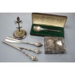 A George V silver mounted hat pin stand, two silver spoons, a silver mounted trinket box, a pair