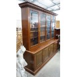 A Victorian style four section mahogany library bookcase, the upper section fitted clear glazed