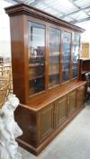 A Victorian style four section mahogany library bookcase, the upper section fitted clear glazed