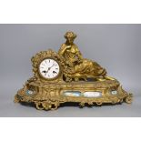 A French gilt metal mantel clock with blue enamel floral decoration and mounted lady reading -