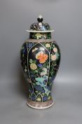 A late 19th century Chinese famille noire enamelled biscuit baluster vase and cover, 49cm high