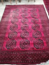 An Afghan red ground carpet, 276 x 200cm