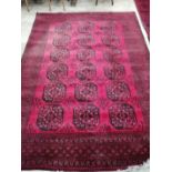 An Afghan red ground carpet, 276 x 200cm
