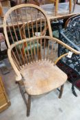 A late 19th / early 20th century elm and beech Windsor comb back elbow chair, width 64cm, depth