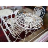 A painted circular metal garden table and 2 folding chairs, table 70 cms diameter.
