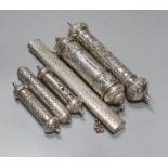 Six assorted 20th century Indian white metal scroll cases, including three pierced, largest 24.5cm.