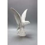 A modern Dresden porcelain model of a perching falcon,37cms high.