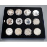 A group of coins including 1898 British Trade One Dollar, Royal Mint UK two QEII five shillings,