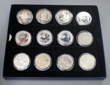 A group of coins including 1898 British Trade One Dollar, Royal Mint UK two QEII five shillings,