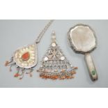 Two shaped Afghan? white metal or parcel gilt white metal, coral bead set pendants, one on a white