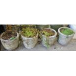 A set of four circular reconstituted stone garden planters, diameter 32cm, height 28cm