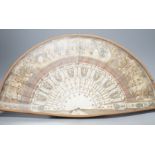 A cased 19th century French lithograph paper leaf and bone stick fan, 56 cms wide.