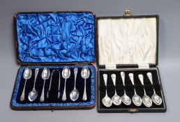 Two cased sets of six silver coffee spoons, including A Victorian set with sugar tongs, the other