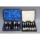 Two cased sets of six silver coffee spoons, including A Victorian set with sugar tongs, the other