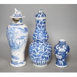 A Chinese double gourd vase and cover, a similar vase and cover and a prunus vase, all 19th