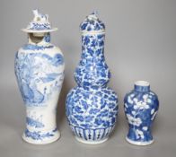 A Chinese double gourd vase and cover, a similar vase and cover and a prunus vase, all 19th