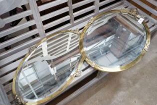 Two Edwardian oval brass framed wall mirrors, larger width 57cm, height 92cm