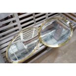 Two Edwardian oval brass framed wall mirrors, larger width 57cm, height 92cm