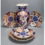 Four Japanese Imari dishes and a vase,vase 31 cms high. (5)