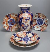 Four Japanese Imari dishes and a vase,vase 31 cms high. (5)