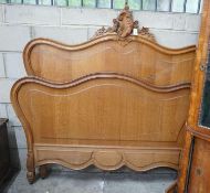 An early 20th century French carved oak double bedframe, width 136cm, headboard height 160cm