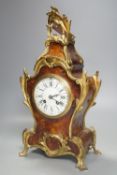 A 19th century French tortoiseshell and ormolu mounted mantel clock,40 cms high.