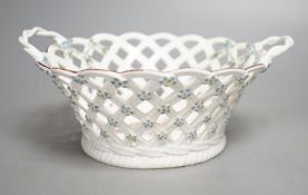 A Chelsea pierced two handled basket the centre painted a large floral bouquet, the handles with
