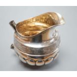 A 19th century Russian 84 zolotnik embossed cream jug, assay master, Michael Karpinsky, 1829,