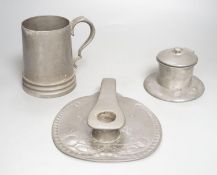 A Liberty Tudric pewter chamberstick, inkwell and mug. Length of chamberstick 18cm, model numbers