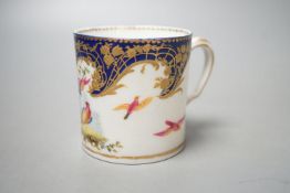 A Sevres coffee can painted with two birds in a tree, and other birds in flight under a richly