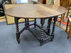 An early 19th century oak bobbin leg gateleg dining table, length 154cm extended, width 108cm,