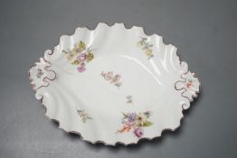 A Chelsea silver shaped dish painted with scattered English flowers under a brown line rim, red