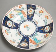 A Worcester saucer shaped dish painted with the blue panelled version of the Sir Joshua Reynolds