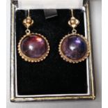 A pair of yellow metal mounted foil backed cabochon amethyst paste set drop earrings, overall