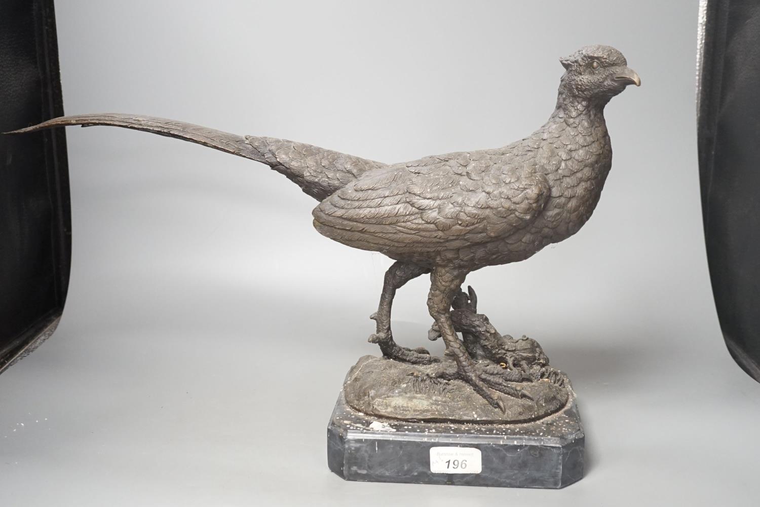 A bronzed metal pheasant, indistinctly signed, on marble base. Length 51cm