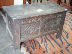 A small 18th century carved oak coffer, with a carved panelled front, length 102cm, depth 47cm,