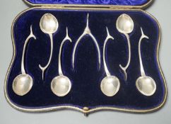 A novelty set of six Edwardian novelty silver wish bone handled teaspoons and matching sugar