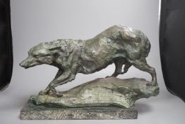 B.C. King, a green patinated bronze of a wolf,43 cms wide.