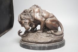 After Barye, a bronzed metal lion and serpent group,25 cms high.