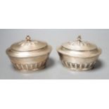 A matched pair of early 20th century silver oval tea caddies, London, 1908 & 191, width 10.5cm and