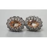 A pair of modern 9ct gold, topaz and diamond set oval cluster earrings, 11mm, gross weight 2.8