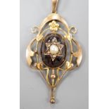 An Edwardian Art Nouveau 9ct, garnet, split pearl and diamond set pendant, overall 57mm, gross