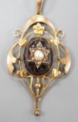An Edwardian Art Nouveau 9ct, garnet, split pearl and diamond set pendant, overall 57mm, gross