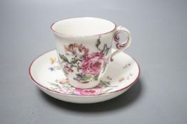 A Mennecy coffee cup and saucer painted with bold flowers, incised 'DV' mark c. 1755