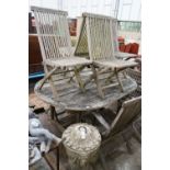 A weathered teak oval garden table, length 178cm, width 120cm, height 77cm and eight folding chairs,