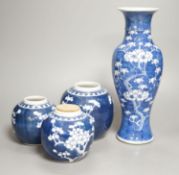 A Chinese blue and white prunus vase together with three similar jars. Vase height 30cm