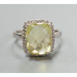 A modern 18ct white gold, fancy cut citrine and diamond cluster set dress ring, size M, gross weight