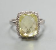 A modern 18ct white gold, fancy cut citrine and diamond cluster set dress ring, size M, gross weight