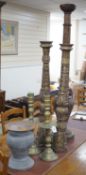 A pair of gilt carved candlesticks, a large turned candlestick, a pair of brass candlesticks and a