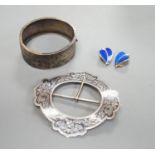 A late Victorian engraved silver hinged bangle, a white metal and niello buckle and a pair of mid